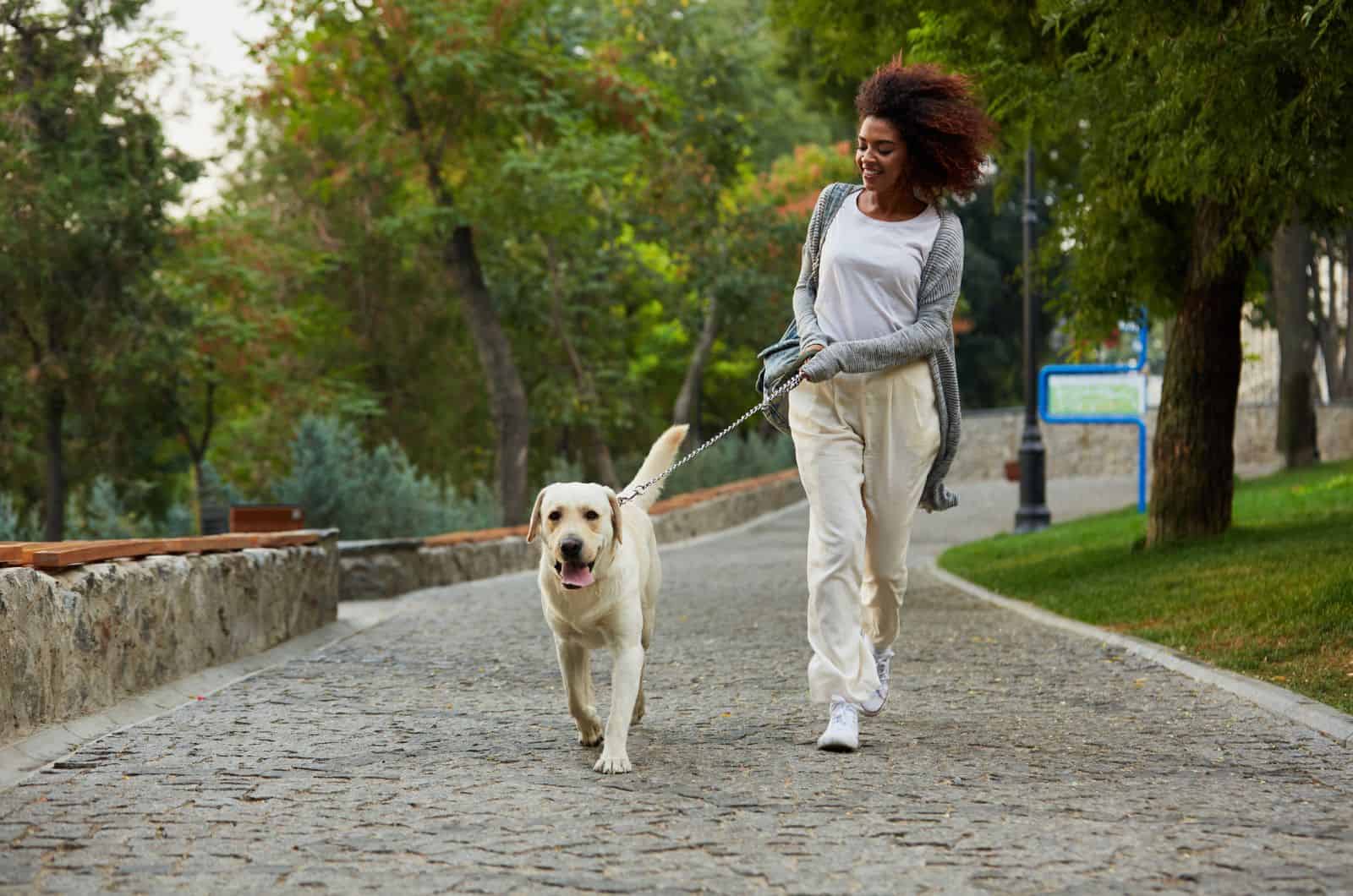 woman walking her dog outside
