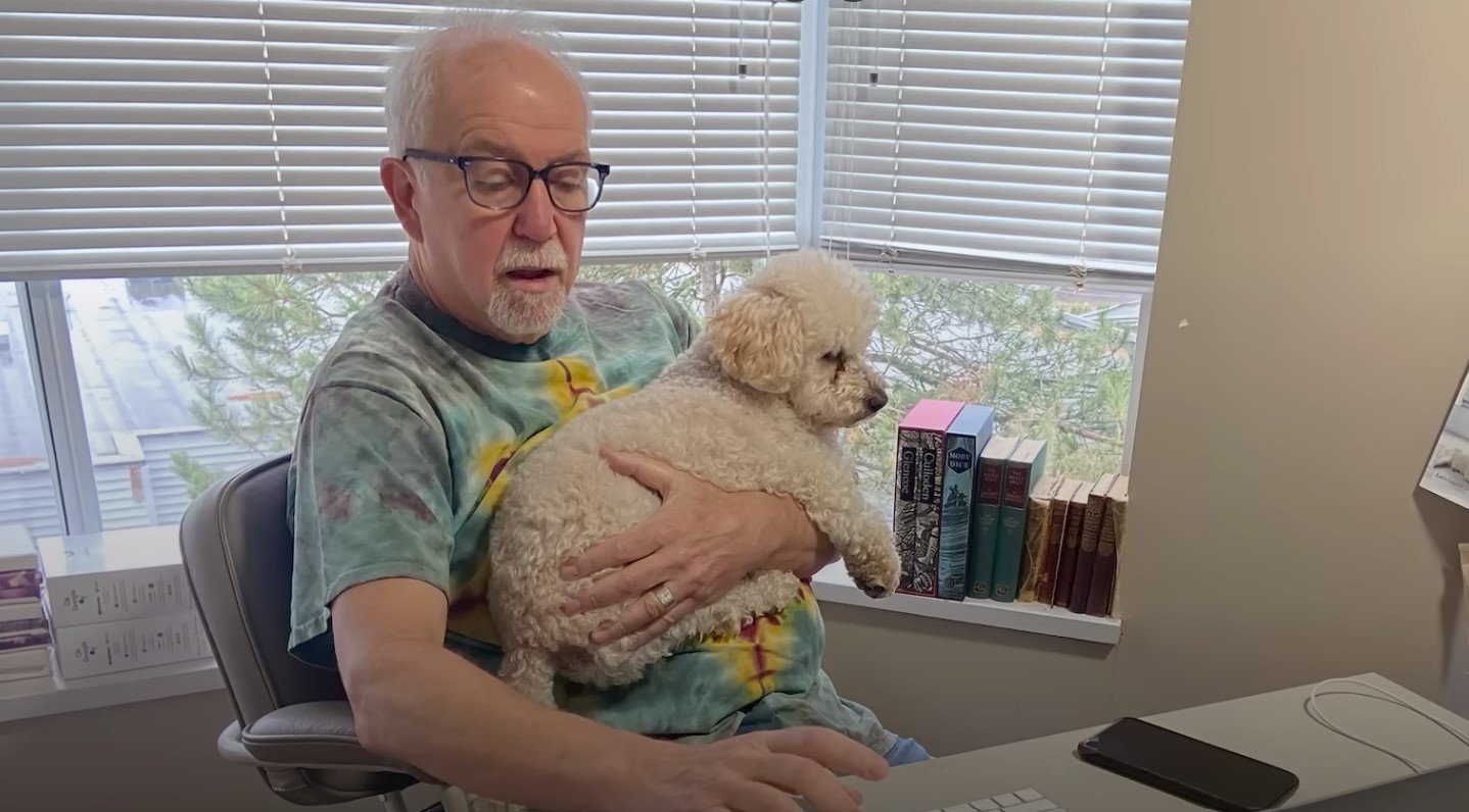 senior man holding a puppy