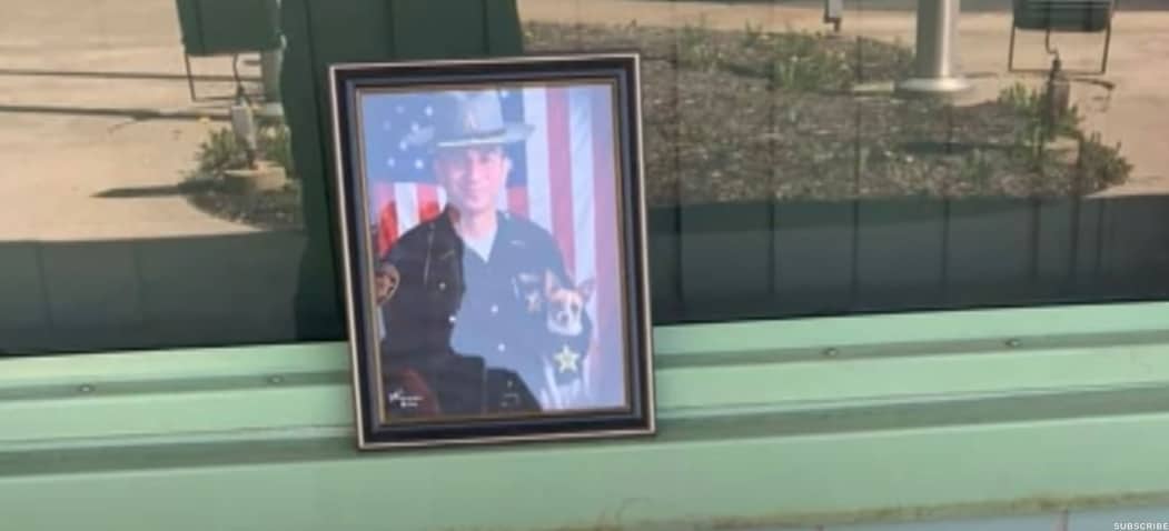 a framed photo of policeman and dog on the bench