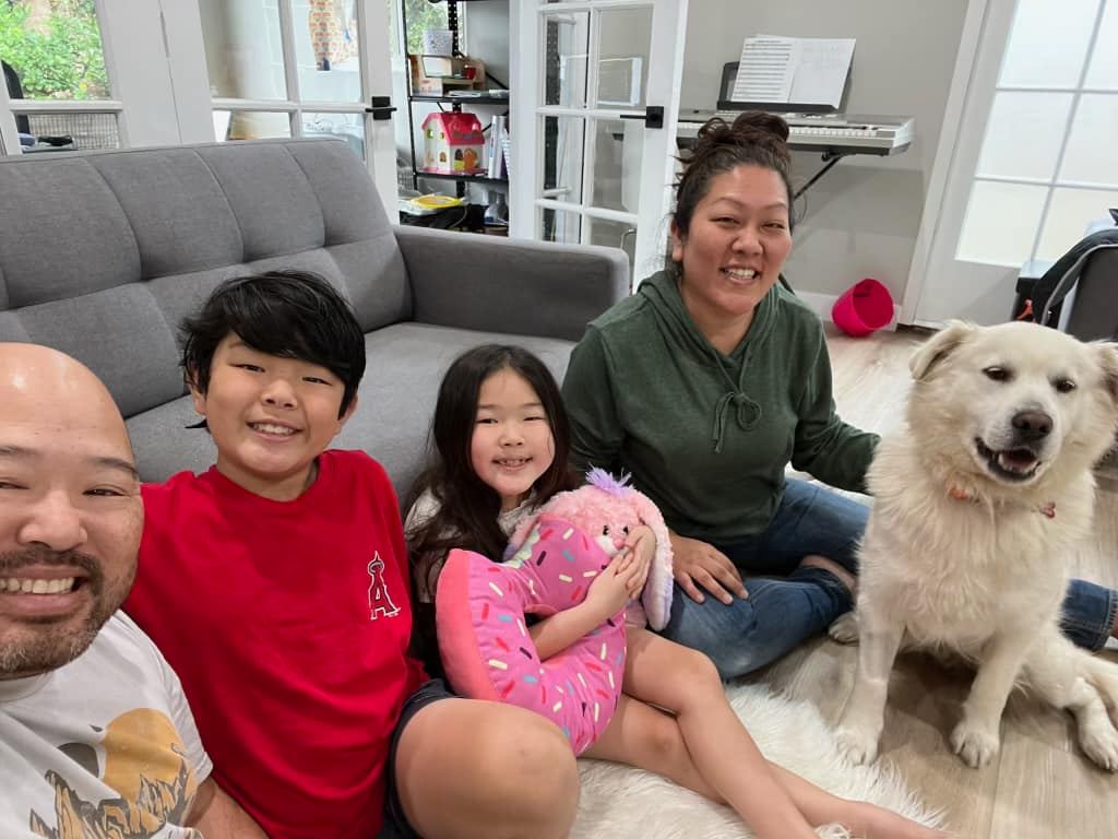 happy family posing with dog