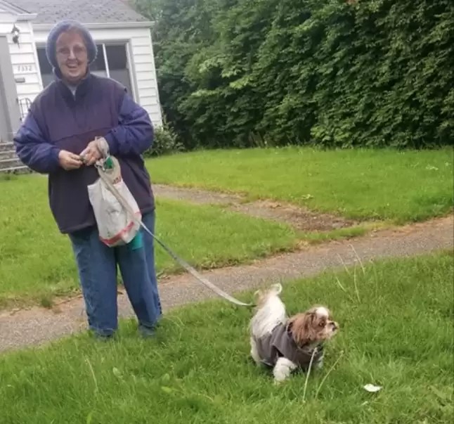 woman walking a dog outside