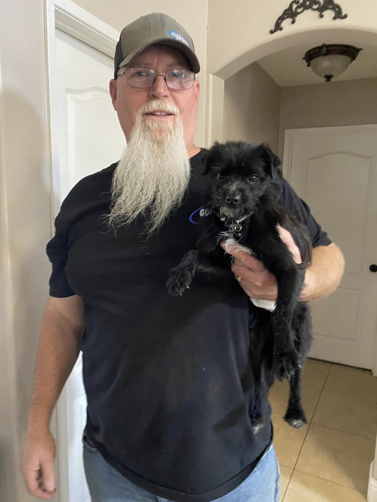 man holding a tiny puppy named rosco