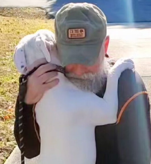 senior man hugging with dog