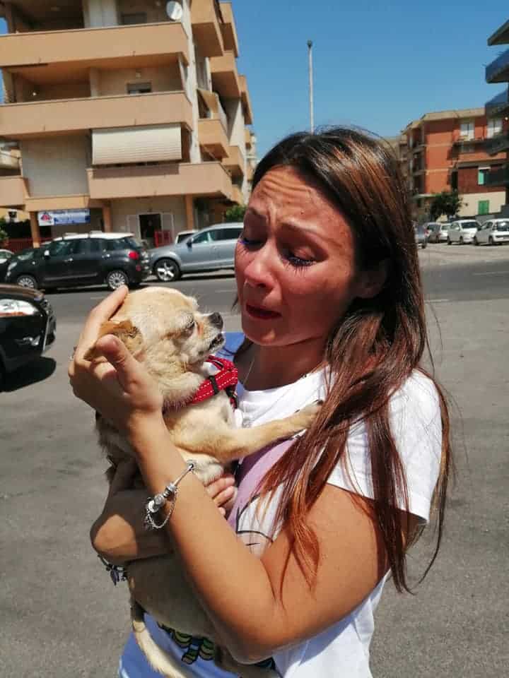 woman holding her dog after 8 years